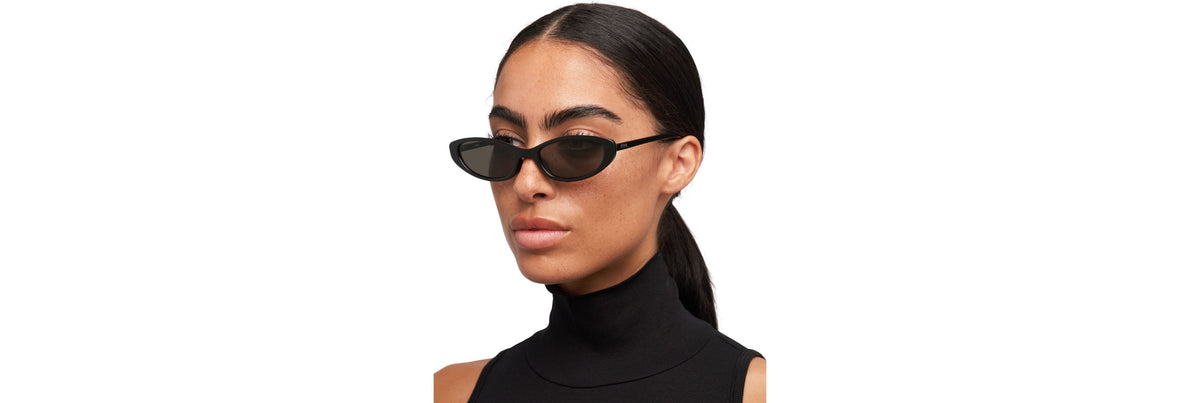 Close-up of acetate sunglasses on a dancer’s face mid‑movement, showing secure temples curving behind the ear without pinching.