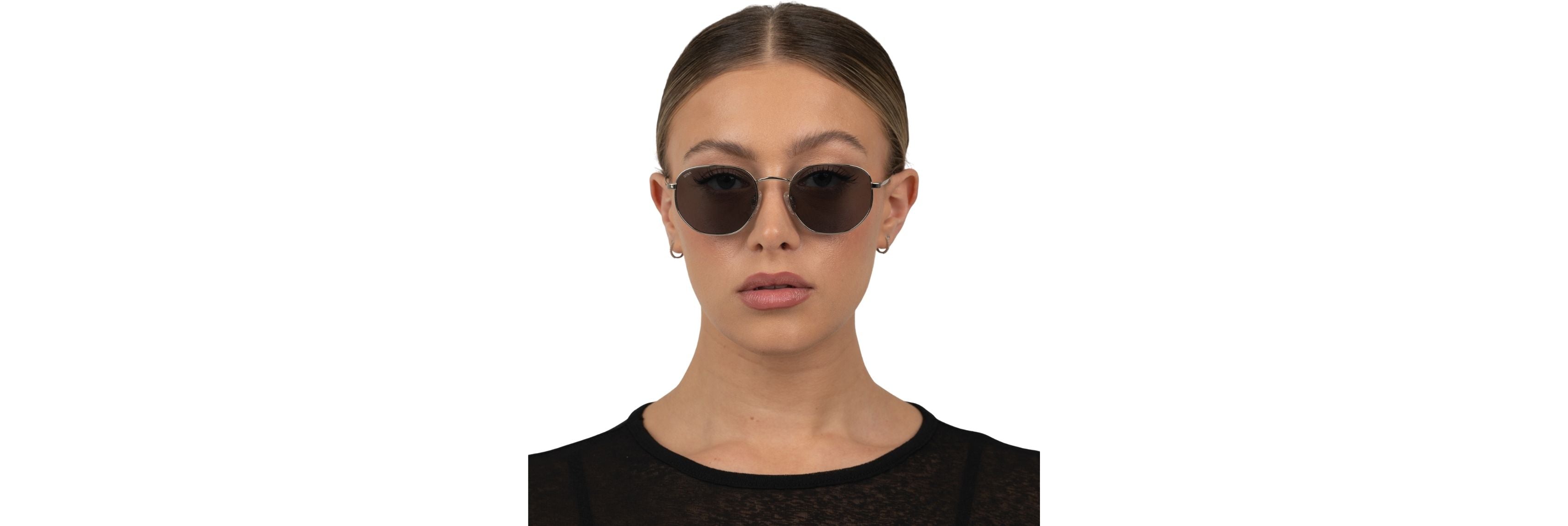 Three people with different head sizes wearing proportional oversized sunglasses—one slim cat-eye, one chunky rectangle, and one soft butterfly—shot in bright, natural light.
