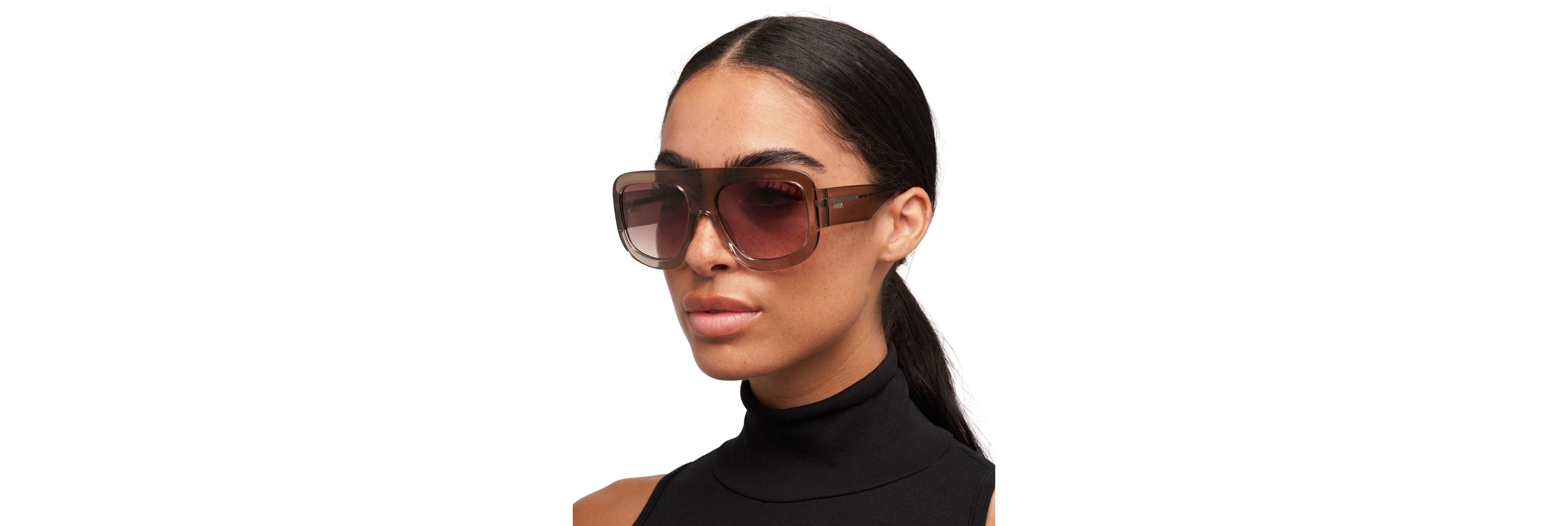An open hard case next to OTRA’s soft vegan pouch on a desk with keys, phone, and tote—showing two smart ways to carry sunglasses all day.