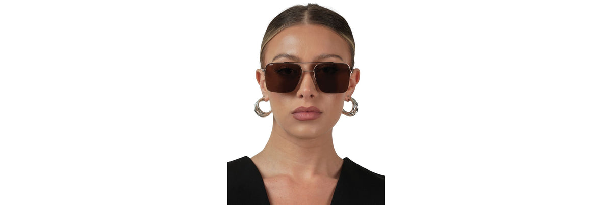 Close-up of sunglasses temple gently curving behind the ear, showing comfortable tip contact without pressure marks.