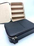 Otra Eyewear - GQ Travel Case - A black zippered leatherette organizer case shown open, revealing a beige interior with five horizontal compartments.