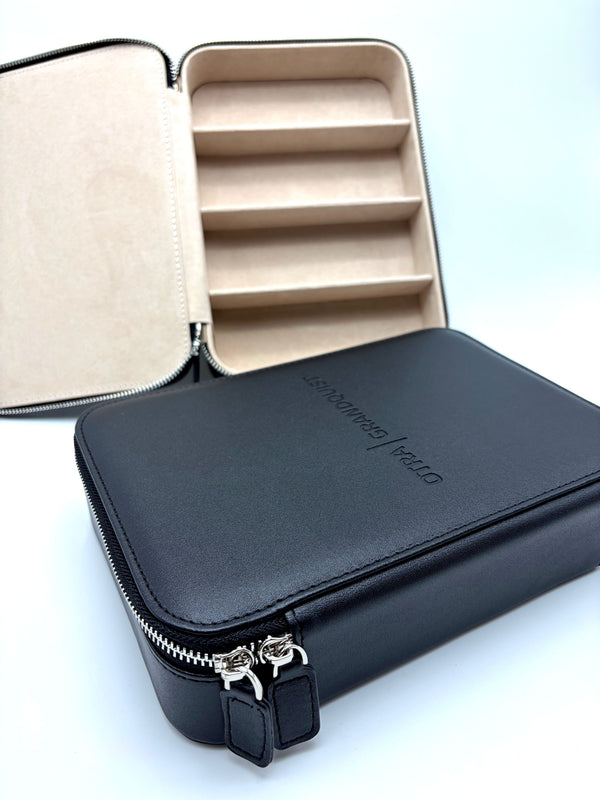 Otra Eyewear - GQ Travel Case - A black zippered leatherette organizer case shown open, revealing a beige interior with five horizontal compartments.