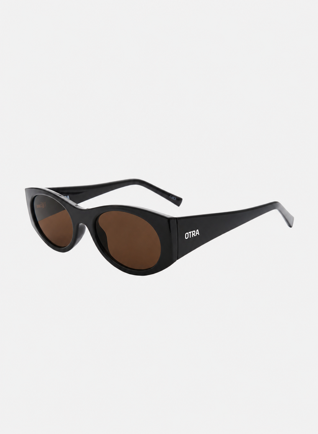 Otra Eyewear - GRACE - Dark Chocolate/Brown - Angled view of GRACE sunglasses in Dark Chocolate/Brown featuring a glossy dark chocolate oval frame, warm brown lenses, and a softly curved silhouette, displayed against a clean light grey background. A timeless everyday style designed for versatile wear with full UV400 protection.