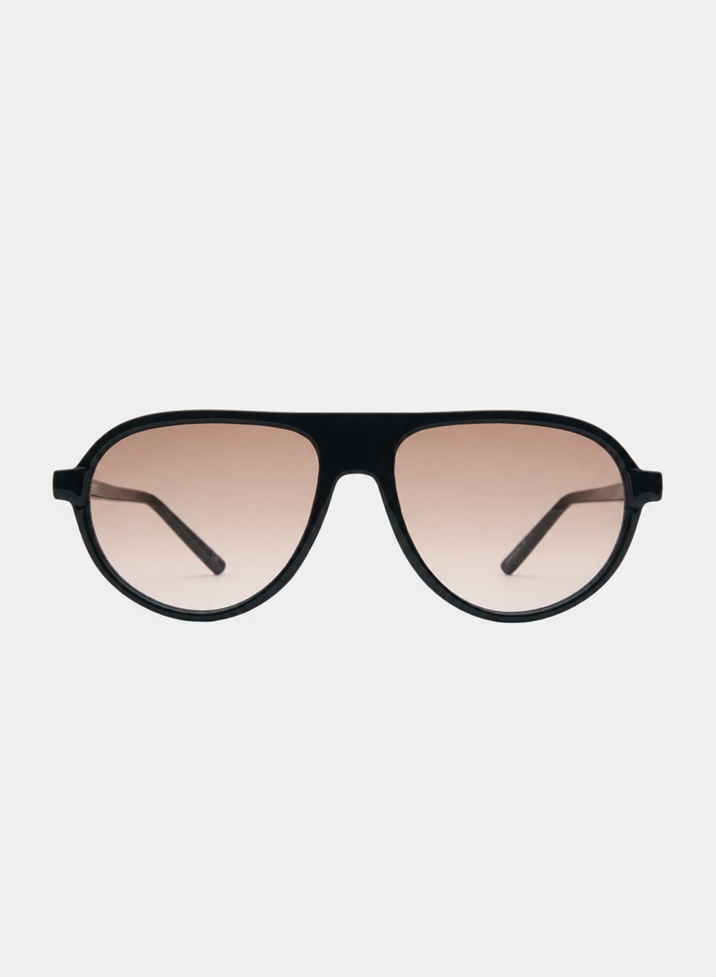 Otra Eyewear - IGGY - Black/Light Brown Fade - Front view of IGGY sunglasses in Black/Light Brown Fade featuring a high-gloss black aviator frame, classic double bridge, and light brown gradient lenses, displayed against a clean grey background. A timeless everyday design with modern styling and full UV protection 