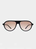 Otra Eyewear - IGGY - Black/Light Brown Fade - Front view of IGGY sunglasses in Black/Light Brown Fade featuring a high-gloss black aviator frame, classic double bridge, and light brown gradient lenses, displayed against a clean grey background. A timeless everyday design with modern styling and full UV protection 