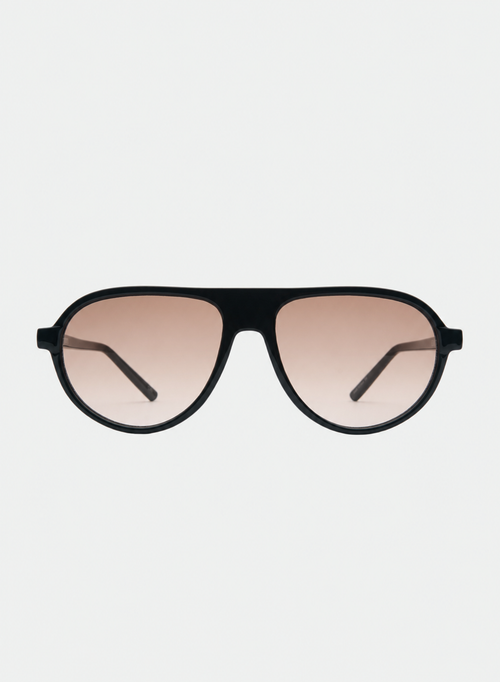 Otra Eyewear - IGGY - Black/Light Brown Fade - Front view of IGGY sunglasses in Black/Light Brown Fade featuring a high-gloss black aviator frame, classic double bridge, and light brown gradient lenses, displayed against a clean grey background. A timeless everyday design with modern styling and full UV protection 