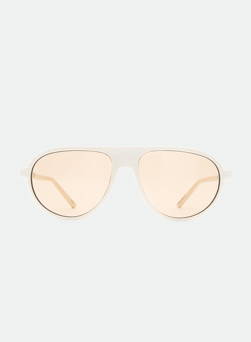 Otra Eyewear - IGGY - Vanilla/Brown - Front view of IGGY sunglasses in Vanilla/Brown featuring a high-gloss vanilla cream aviator frame, classic double bridge, and light brown lenses. Front-facing editorial portrait showcasing the timeless everyday silhouette with a clean, modern aesthetic in grey background.