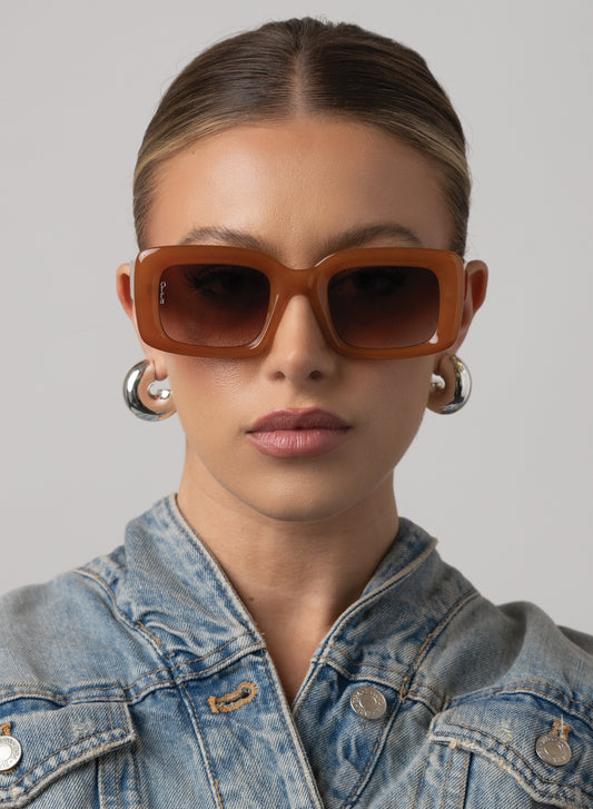 model wearing Chelsea oversized rectangular glasses in honey color