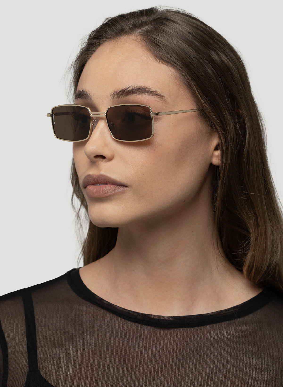 Side view of model wearing Ila small rectangle sunglasses