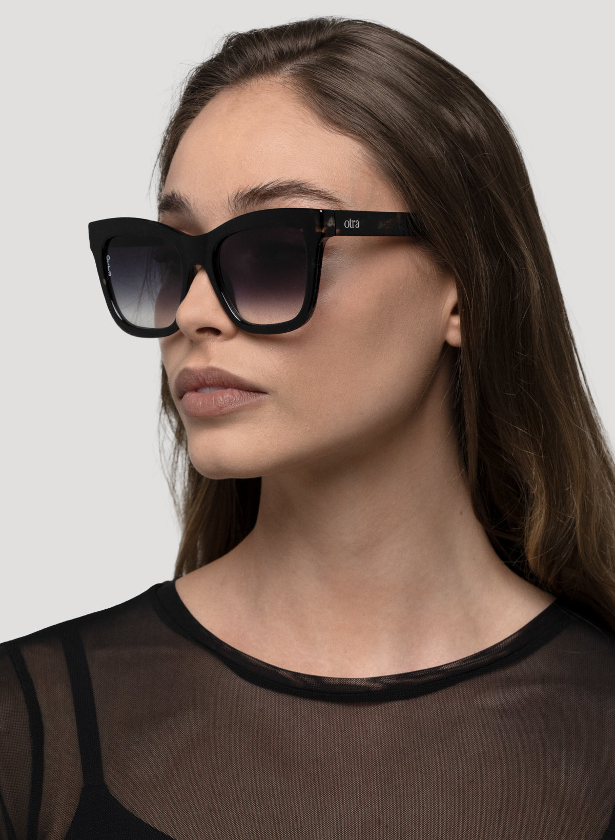 Side view model wearing Irma oversized cat eye sunglasses in black tortoiseshell