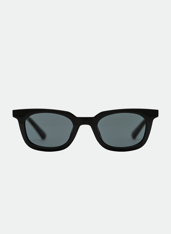  Otra Eyewear- Nia - Black - Front view of the Nia classic black wayfarer sunglasses featuring a polished black acetate frame and deep dark smoke black lenses against a clean light grey background.