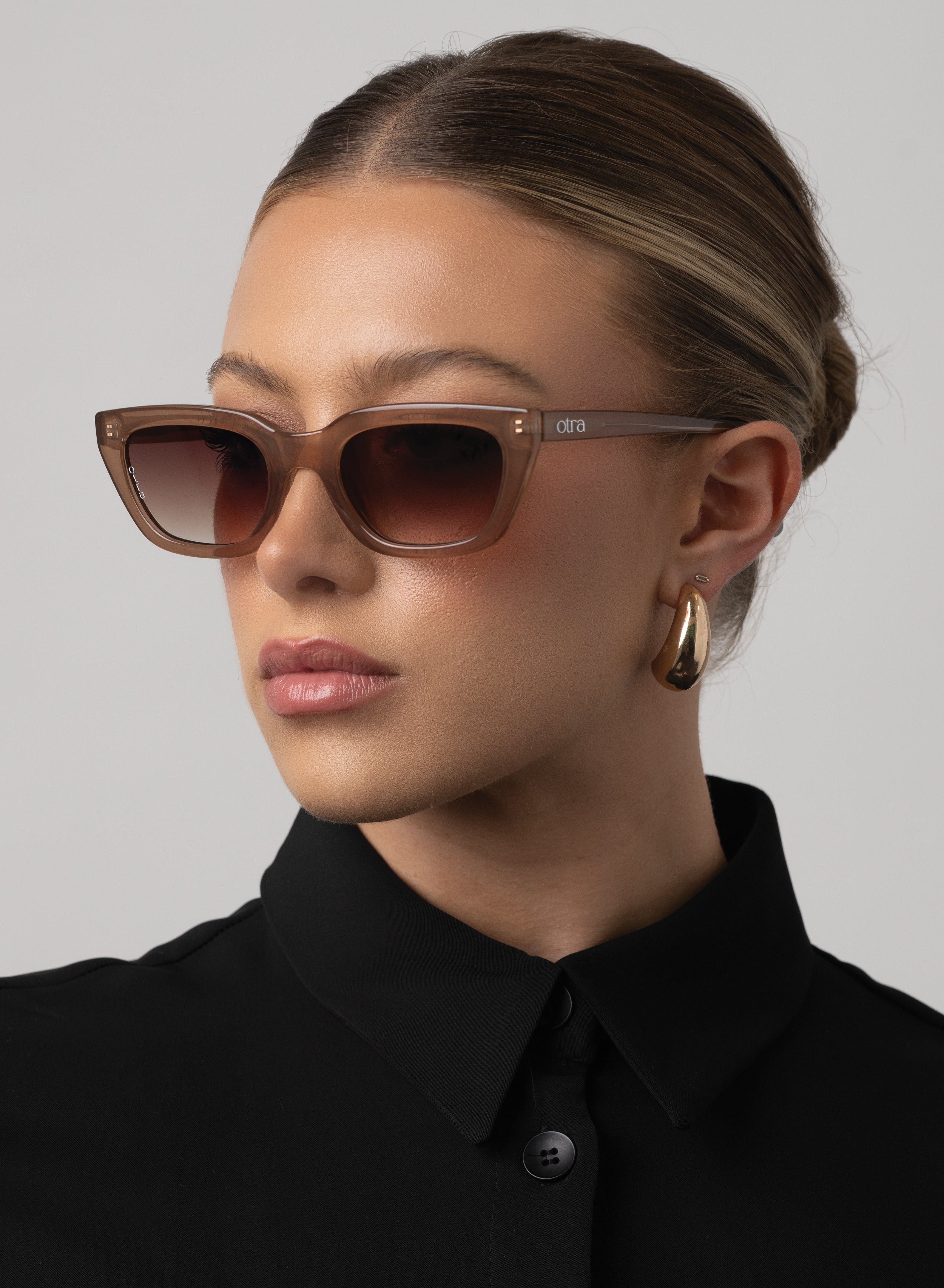 Black rectangular Otra sunglasses on white background