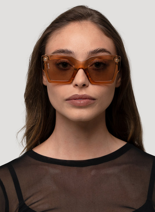 Model wearing Pipa oversized cateye sunglasses in transparent gold