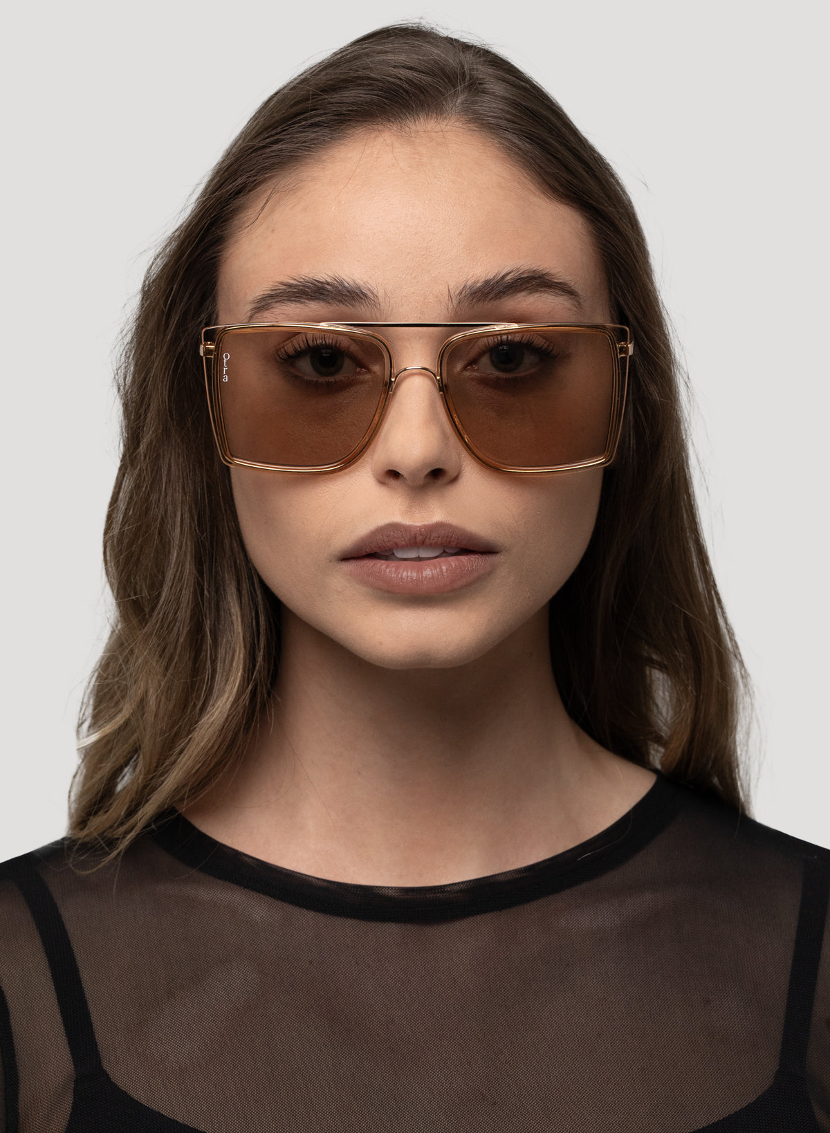 Model wearing Velda oversized square aviator sunglasses in gold