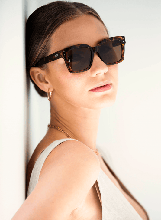Model wearing ORA square sunglasses in brown tortoiseshell